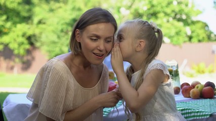 Cheerful daughter sharing secret with mother, telling about first love, trust