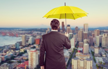 Portrait of  businessman with umbrella on background