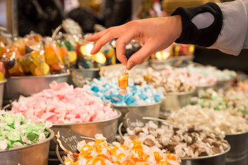 Buckets filled with taffy candy at a candy shop.