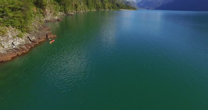 Man in kayak navigating the Tagua Tagua lake and its surroundings on a sunny day
