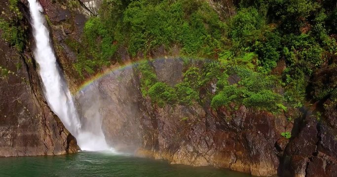 Aerial view of the Velo de la Novia waterfall that flows into Lake Tagua Tagua, surrounded by native forest