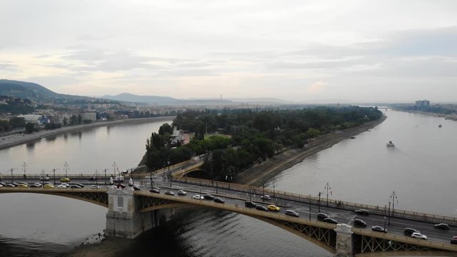 Budapest Margaret Island (Margitsziget) and Margit Hid (Margaret bridge) filmed by drown with traffic moving on the bridge