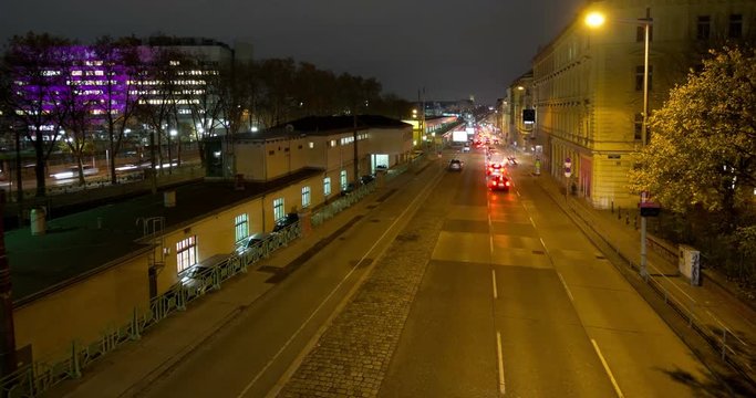Nightly traffic time-lapse zoom in on the Waehringer Guertel at Michelbeuern, where the Vienna General Hospital AKH is located. Cars driving by producing light trails.
