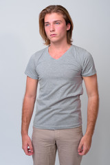 Obraz premium Young handsome man with long blond hair