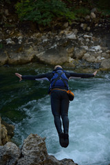Man jumping in wild river
