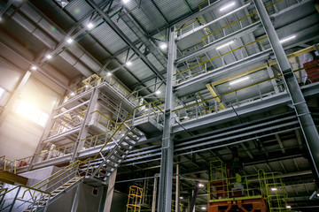 Inside modern Chemical factory production line. Industrial equipment, cables, vats and piping