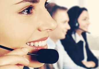 Female call center employee with coworkers