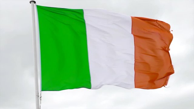 Irish flag waving in the wind in slow motion with a white background