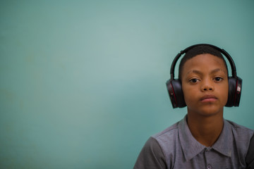 Portrait of kid listening to music on headphones