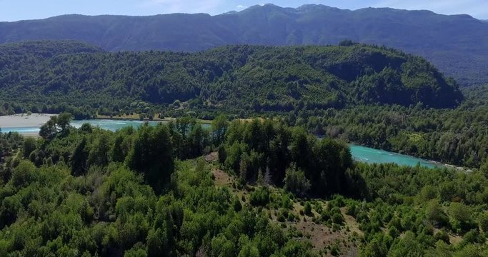 Aerial view at low altitude of the Traidor River surrounded by native and pristine forest, Chilean Patagonia