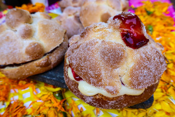 Pan de Muerto (Bread of the Dead) Filled with Cream and Raspberry Jelly for Day of the Dead Holiday in Mexico City