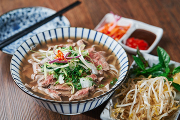 Vietnamese Phở Beef Noodle Soup Bowl with vegetable