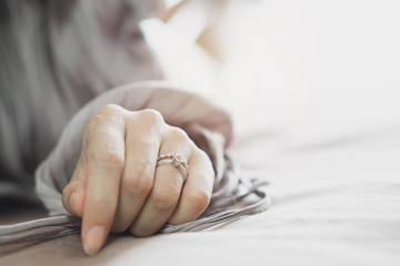 Close up of an elegant diamond ring on woman finger. soft and selective focus. Love and wedding...