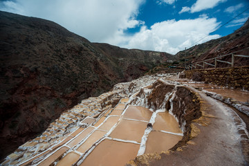Maras salt evaporation ponds, and the surrounding scenery in sacred valley, Perù.