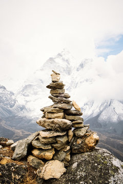 View of cairn marks against snowcapped mountain