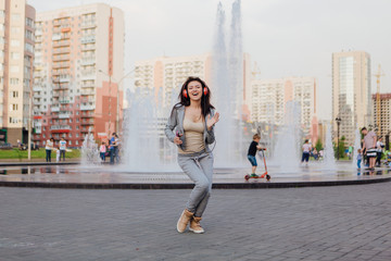 Young woman listening to music streaming with headphones.