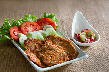 Fried fish pasty mix with curry in white dish and vegetable pickled sauce in cup