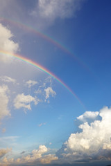 Rainbow in blue sky with cloud for background                             