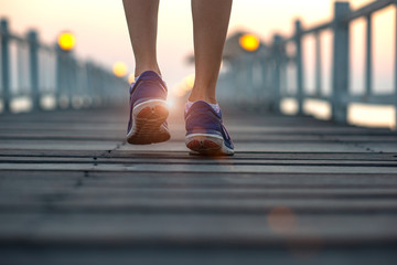 legs of woman walking jogging exercise daily morning on wooden pier, exercise daily run