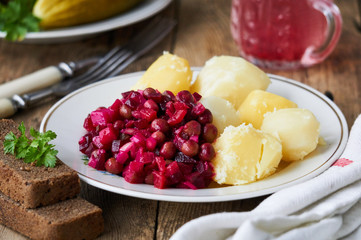 Vegetable salad vinaigrette and boiled potatoes on a plate