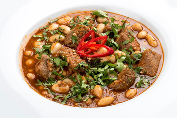 Spicy beans with pork. On a white background