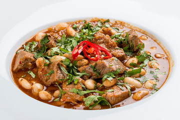 Spicy beans with pork. On a white background