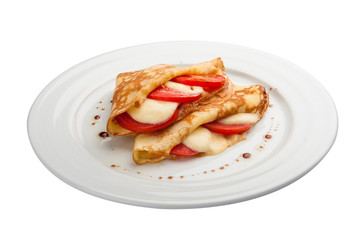 Breakfast. Pancakes with mozzarella and tomatoes. On a white background