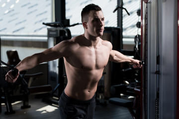 Fototapeta na wymiar Young Man Exercising Chest In The Gym