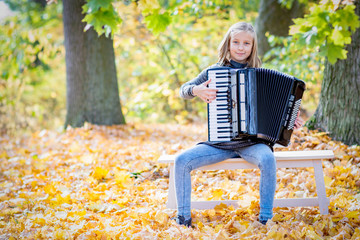 Young girl playing an Accordion outdoor