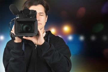 Cameraman with his camera on blurred background