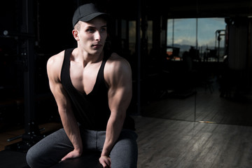 Attractive Young Man Resting In Gym Afther Exercise