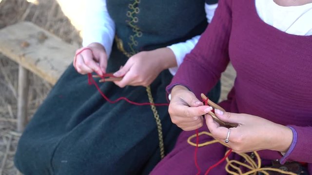 Handmade Genoese Paracord Buckle Bracelet. Young girls in historical medieval dresses