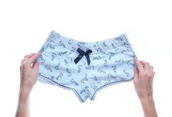 Hands folding panties isolated on white background. Top view..