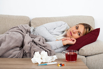 Woman with influenza on the sofa