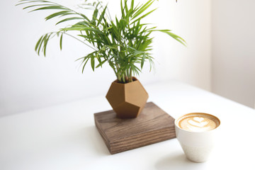 Cappuccino with beautiful latte art on white table background.