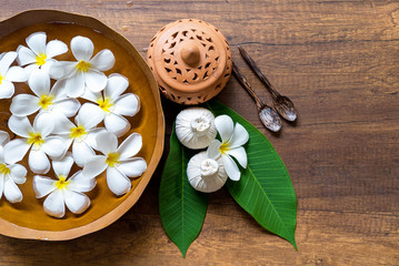 Spa Thai setting for aroma therapy and sugar and salt massage with flower on the bed, relax and healthy care.  Healthy Concept