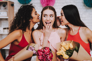 Three Happy Women with Bouquets Flowers on March 8