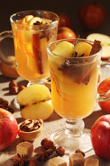Two cups with hot cider in cold season with cinnamon and anise