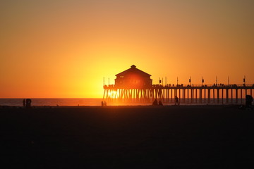 sunset behind pier
