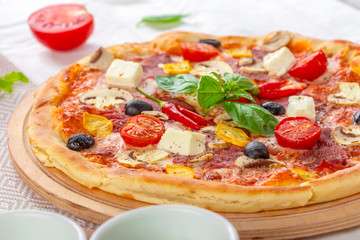 Pizza with Mozzarella, Ham, Cherry Tomatoes, Black Olives