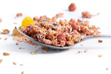 Photo of Full spoon of granola isolated on white background