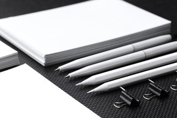 Branding mock up. Blank corporate stationery set on black paper background.