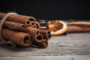 Cinnamon sticks on wooden background.