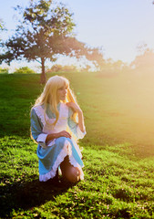 Fototapeta premium Pretty young blonde with a long hair outdoors