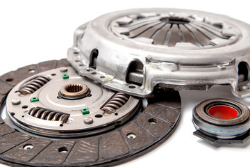 Set of replacement automotive clutch isolated on white background. Disc and clutch basket with...