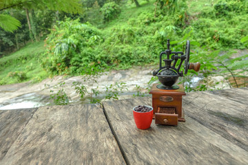 Fototapeta na wymiar Vintage coffee grinder on a table. Drip coffee machine for yourself with natural view backgrounds