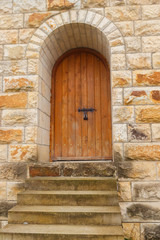 Closed wooden door on stone wall