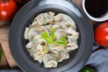 Asian dumplings in bowl, chopsticks, Chinese dumplings for dinner.Chinese dumplings for dinner/lunch. Traditional Asian/Chinese cuisine.