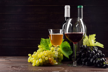Wine bottle and grape on wooden table