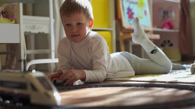 house lifestyle. a little boy plays in the children's room with a toy train